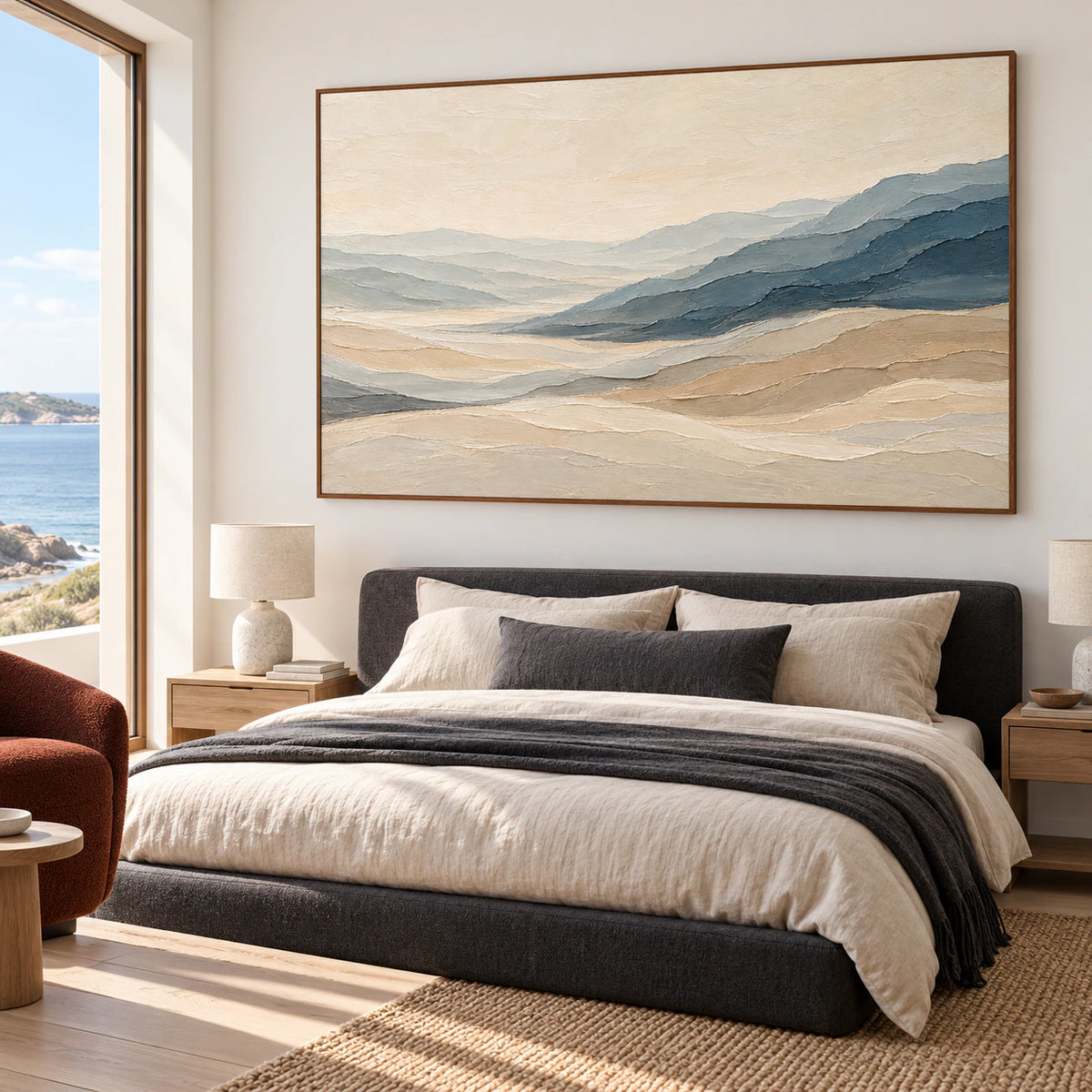 Horizontal abstract landscape above a low, dark upholstered bed in a quiet, daylight-filled bedroom.
