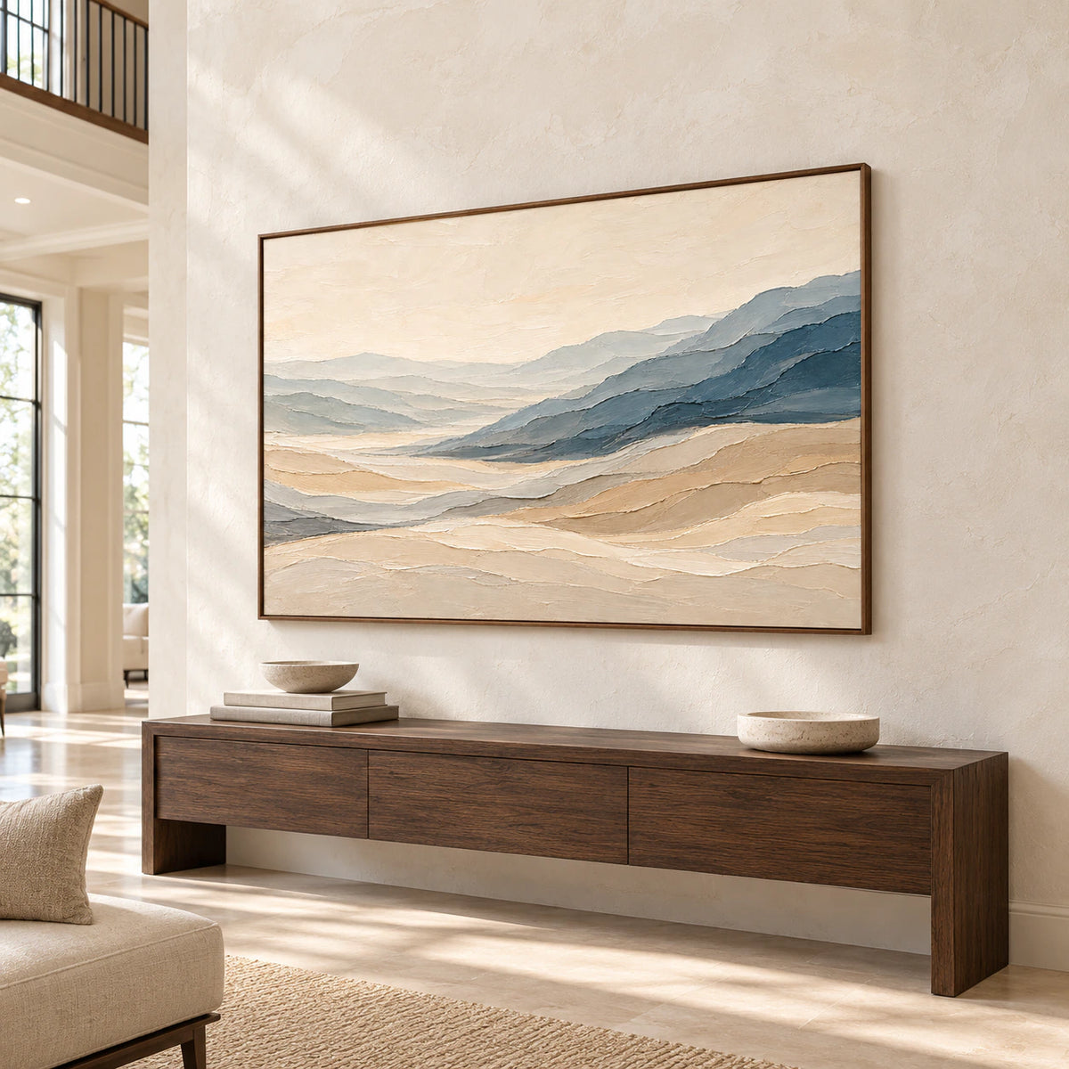 Impressive horizontal artwork on a tall foyer wall beneath a high ceiling, with daylight and a clear view of its layered ridges.