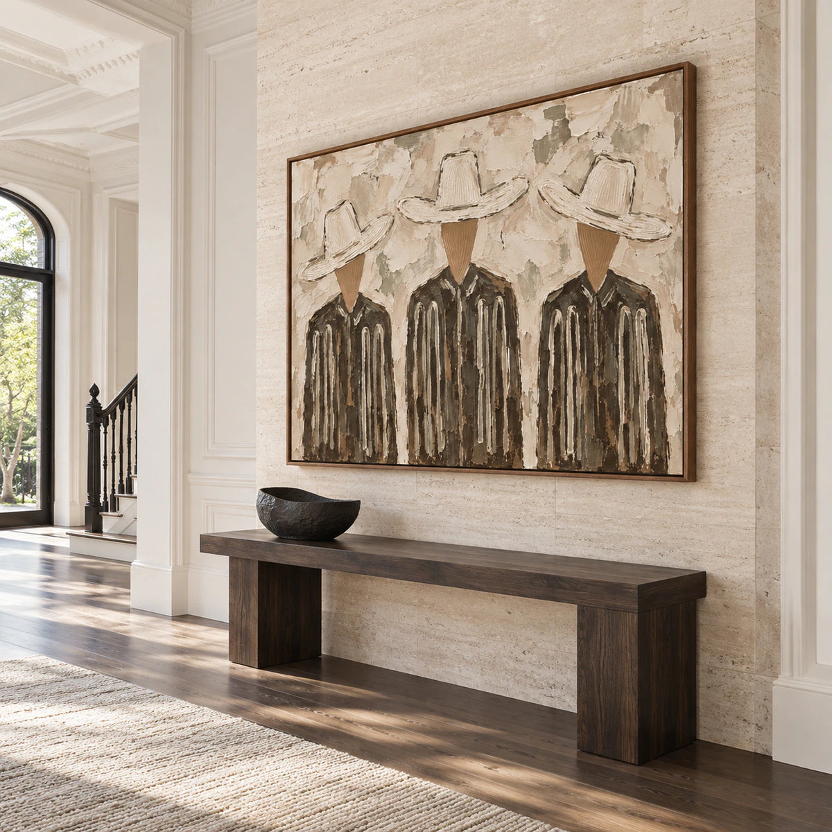 Gallery-scale textured figure artwork in a sunlit stone foyer.