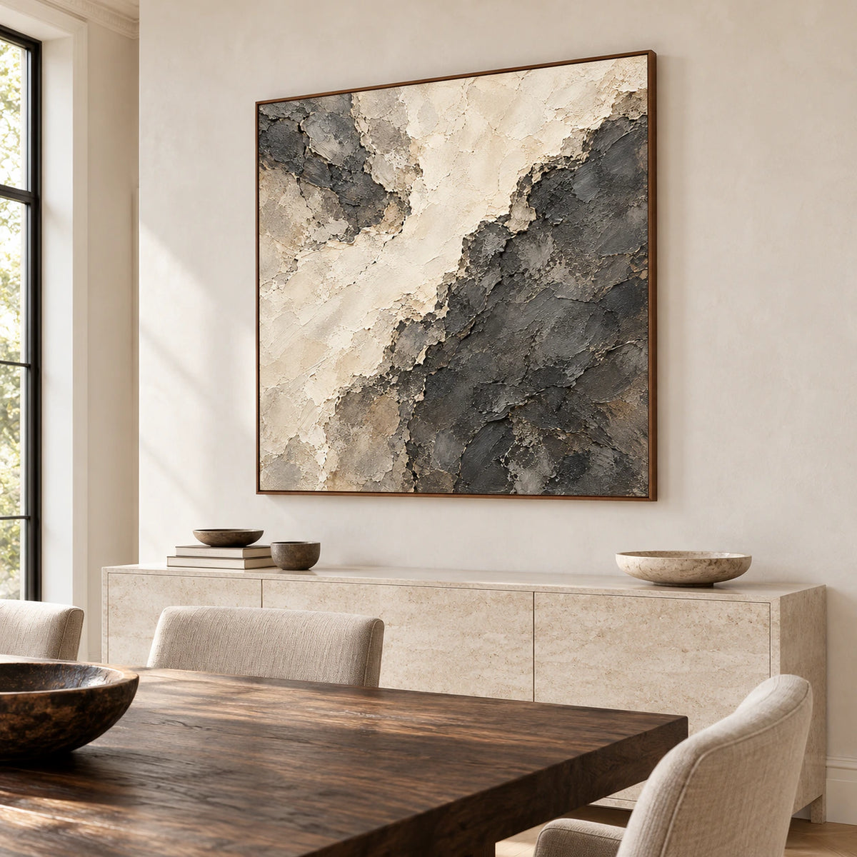 Soot-Divide above a pale stone sideboard in a bright dining room, with a long timber table in the foreground, viewed slightly from the right.