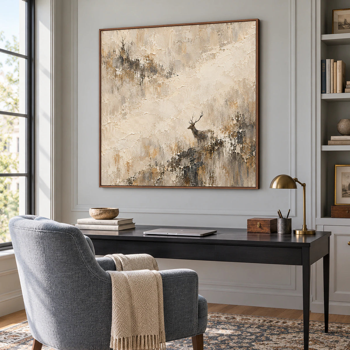 Square textured artwork in an airy home office beside a reading chair and desk.