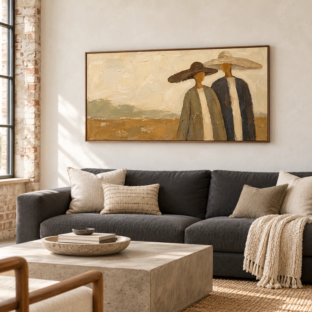 Still-Company displayed prominently above a charcoal sofa in a bright living room with pale walls and natural daylight.