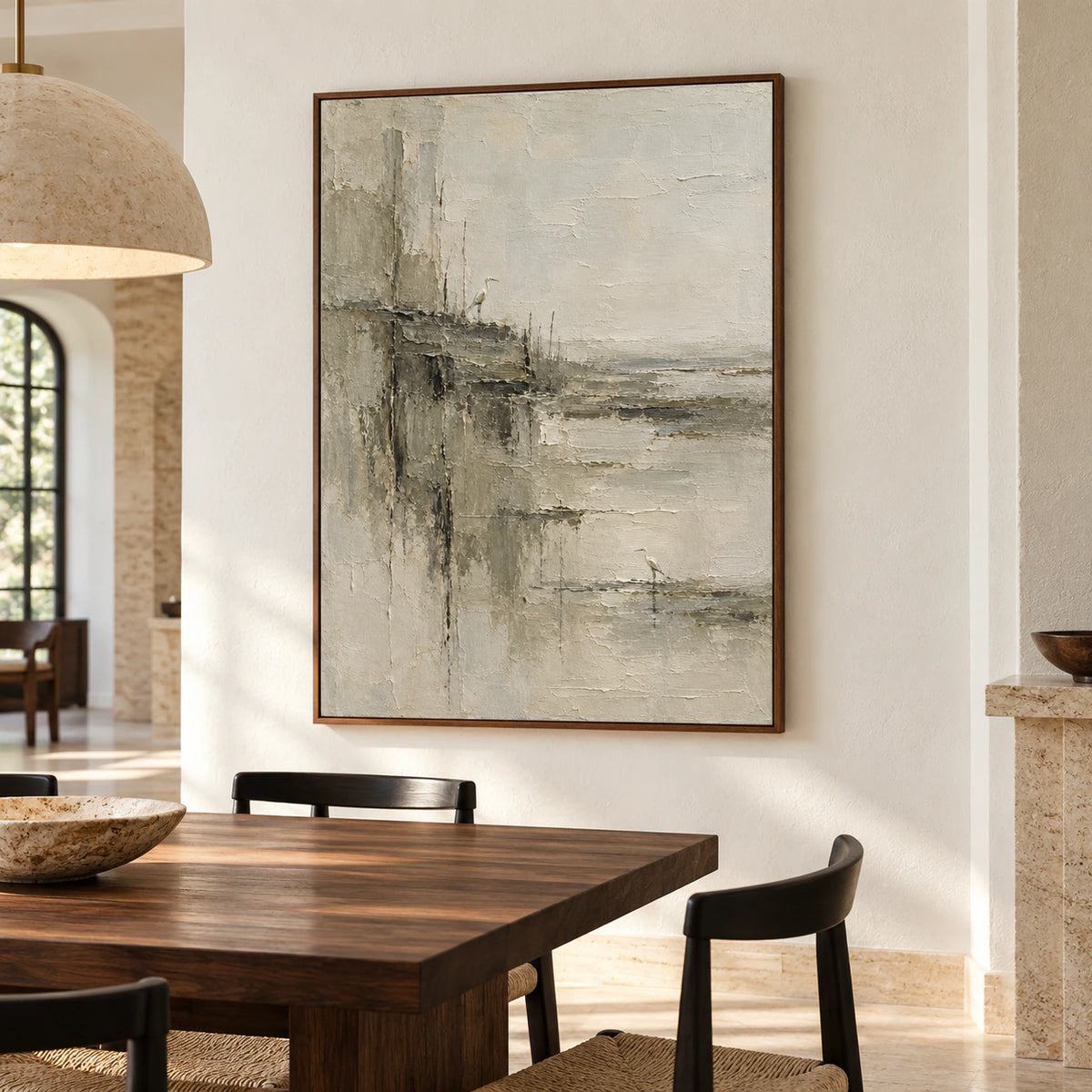 The vertical artwork anchors a refined dining room with a long table and daylight.