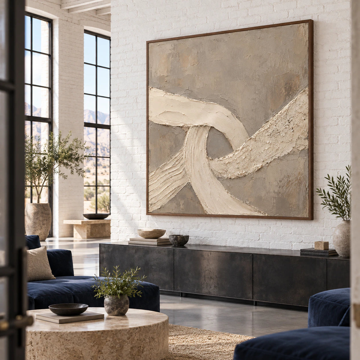 Square ivory and taupe textured abstract artwork in an expansive loft hospitality interior.