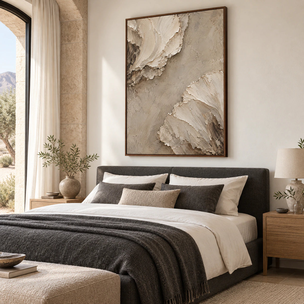Sculptural ivory and sand abstract painting in a quiet, bright bedroom.