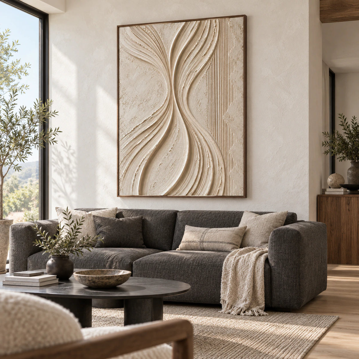 Ivory textured abstract wall art above a restrained sofa in a bright living room.