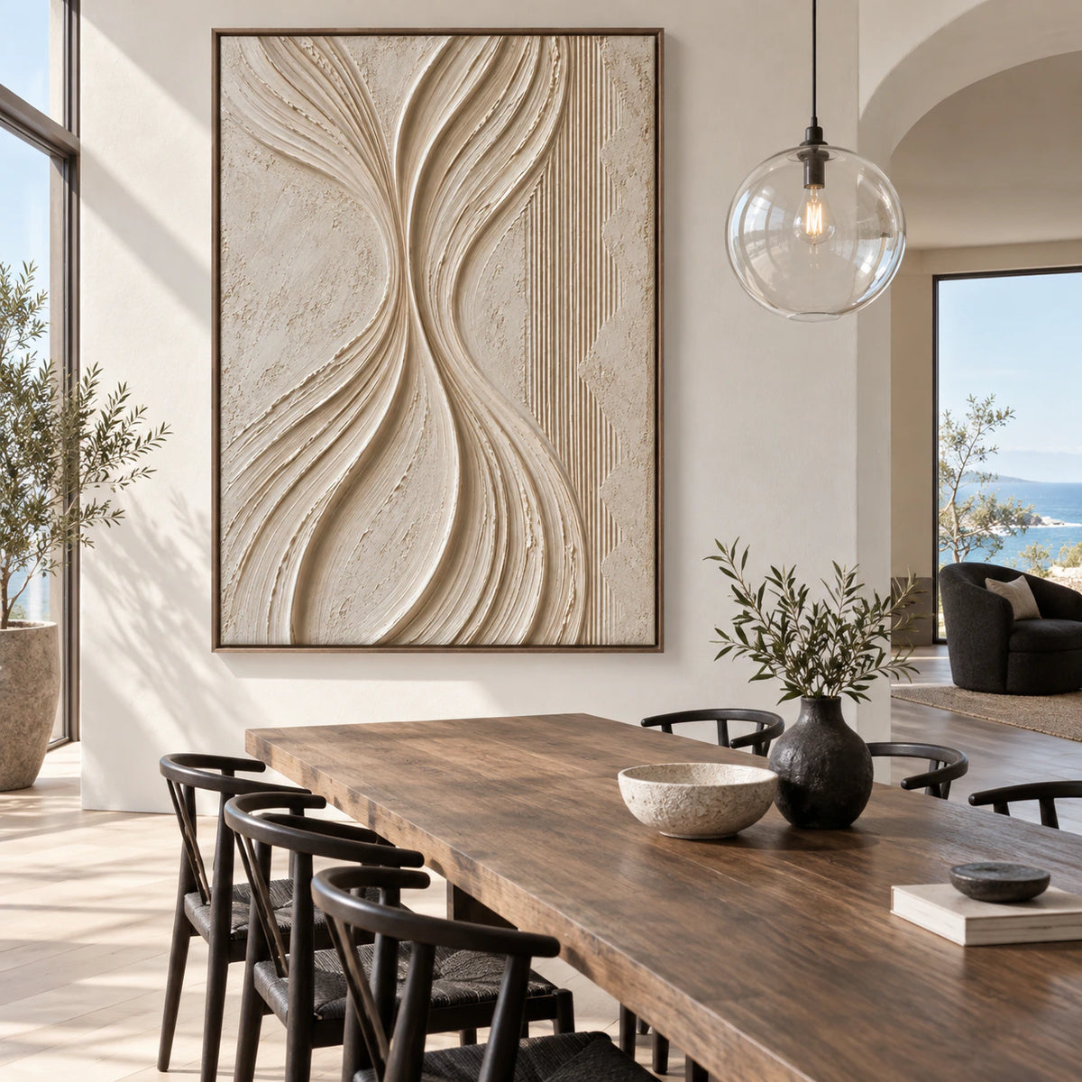 Vertical ivory relief artwork anchoring a refined daylight dining room.