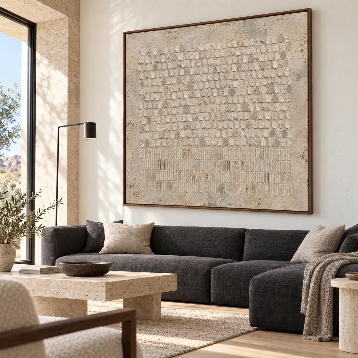 Square textured abstract painting above a pale contemporary sofa in a bright living room.