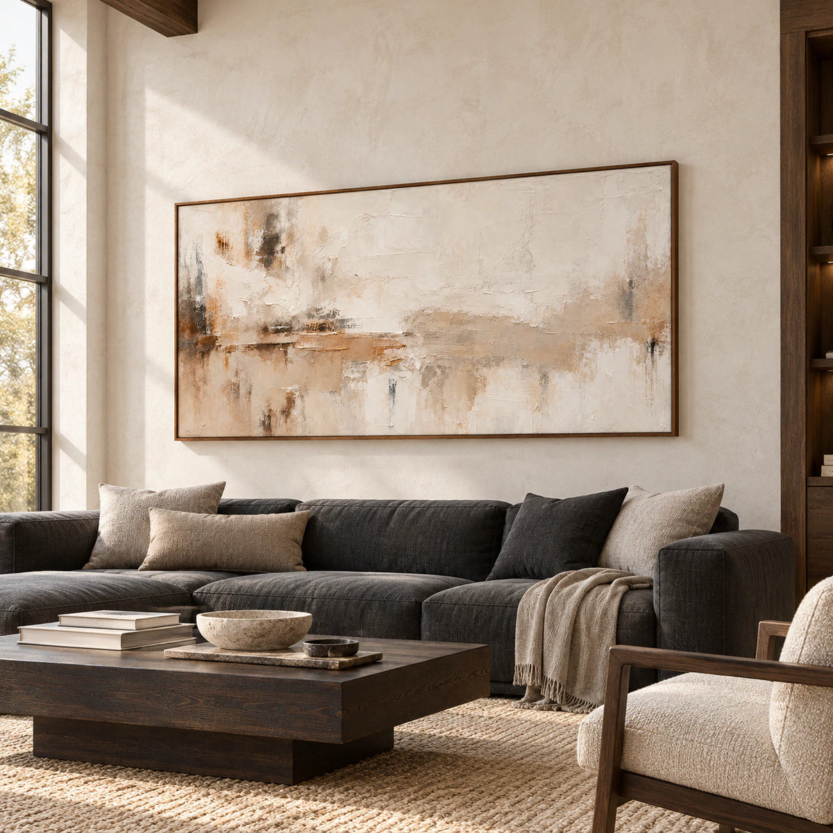 Tawny-Palimpsest above a low charcoal sofa against a pale stone living room wall, viewed from a slight left angle in natural daylight.