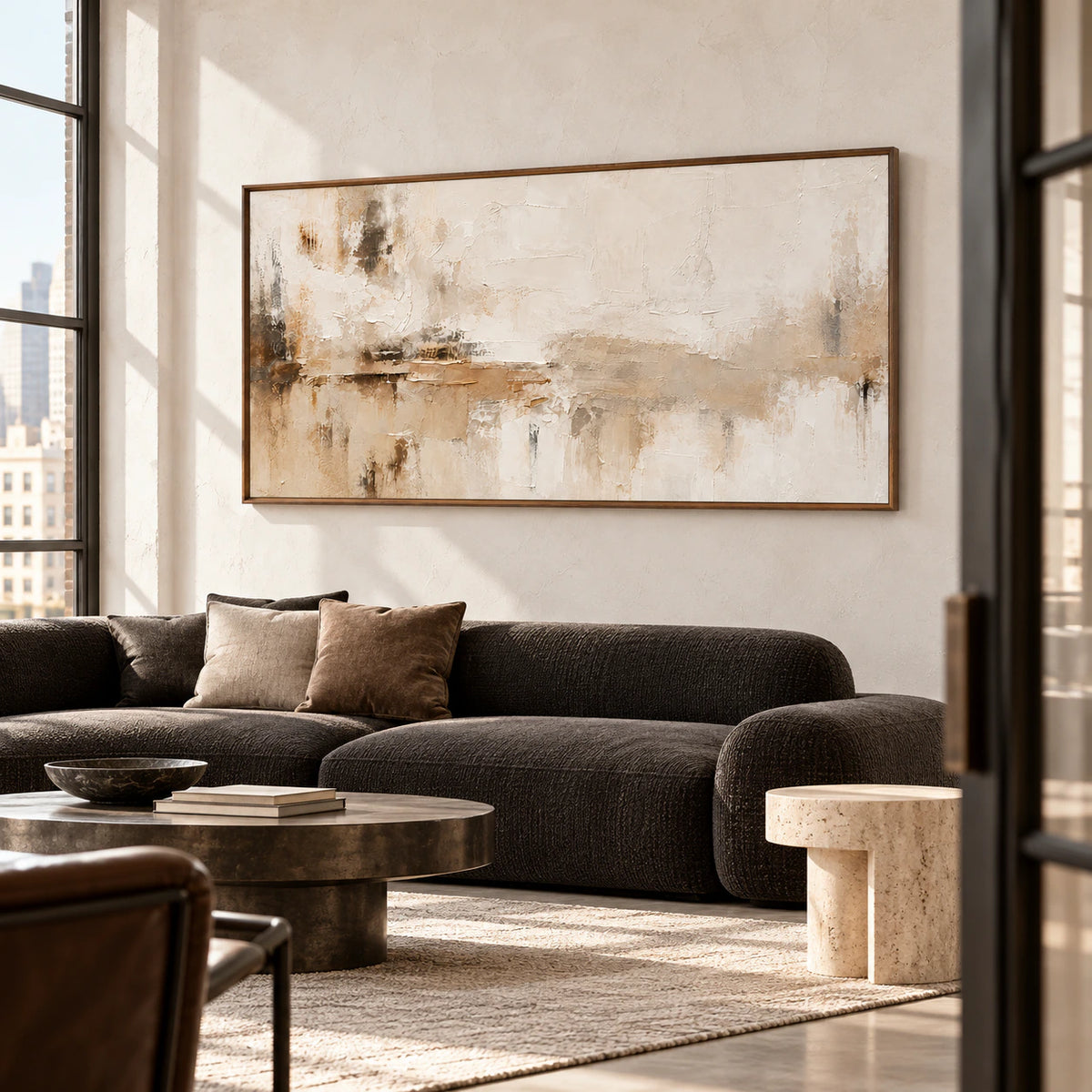 Tawny-Palimpsest on a light wall in an expansive lounge with tall windows, a dark low sofa and sparse sculptural furnishings, viewed from a slight right angle.