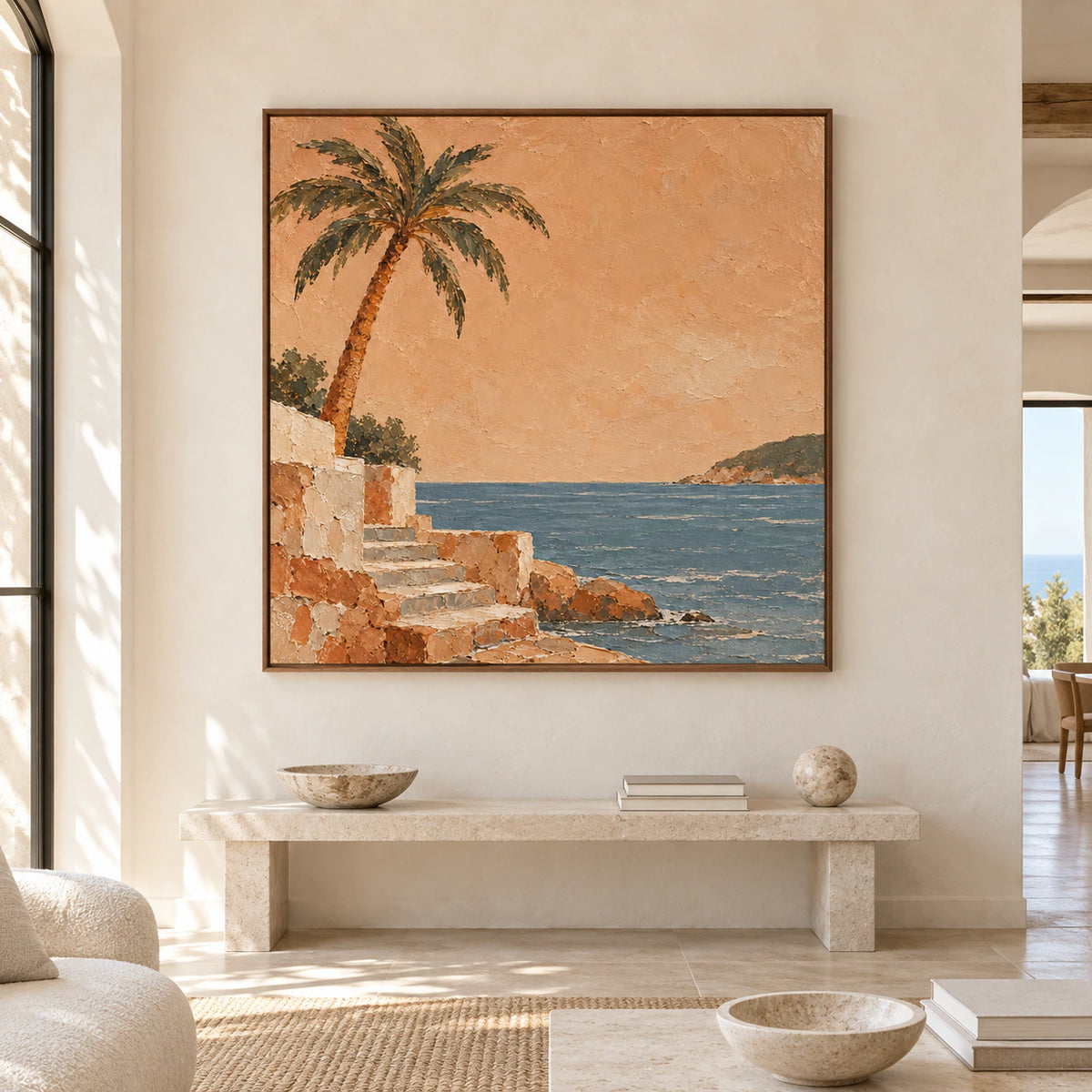 Large square coastal painting shown straight-on above a low stone console in a spacious, bright room.