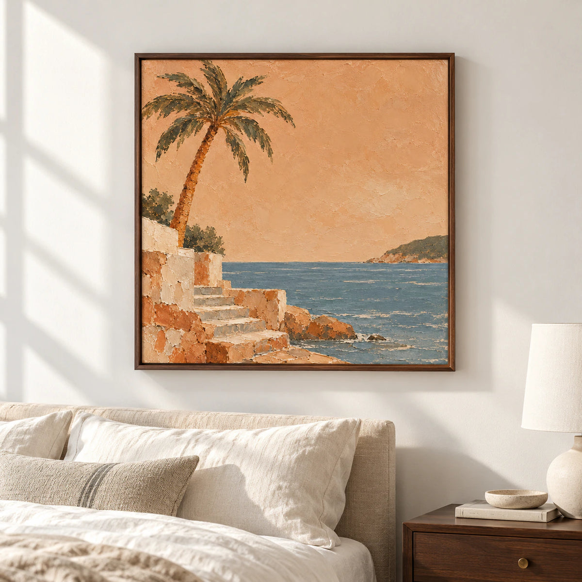 Square coastal artwork above a low bed in a quiet bedroom with crisp ivory bedding and restrained dark wood details.