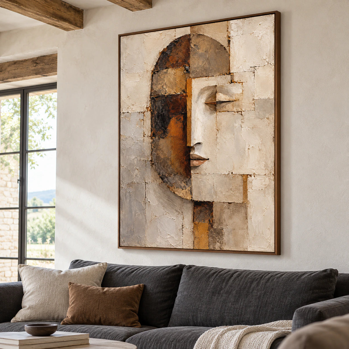 Large abstract portrait above a restrained charcoal sofa in a bright living room.