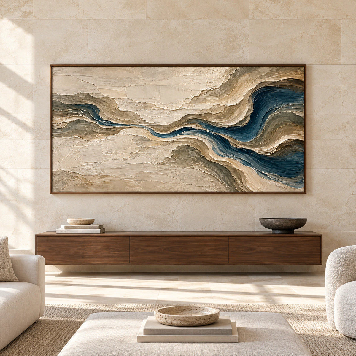 Straight-on view of Tidal-Gesso above a low console on a broad pale limestone wall in a bright, spacious living room.