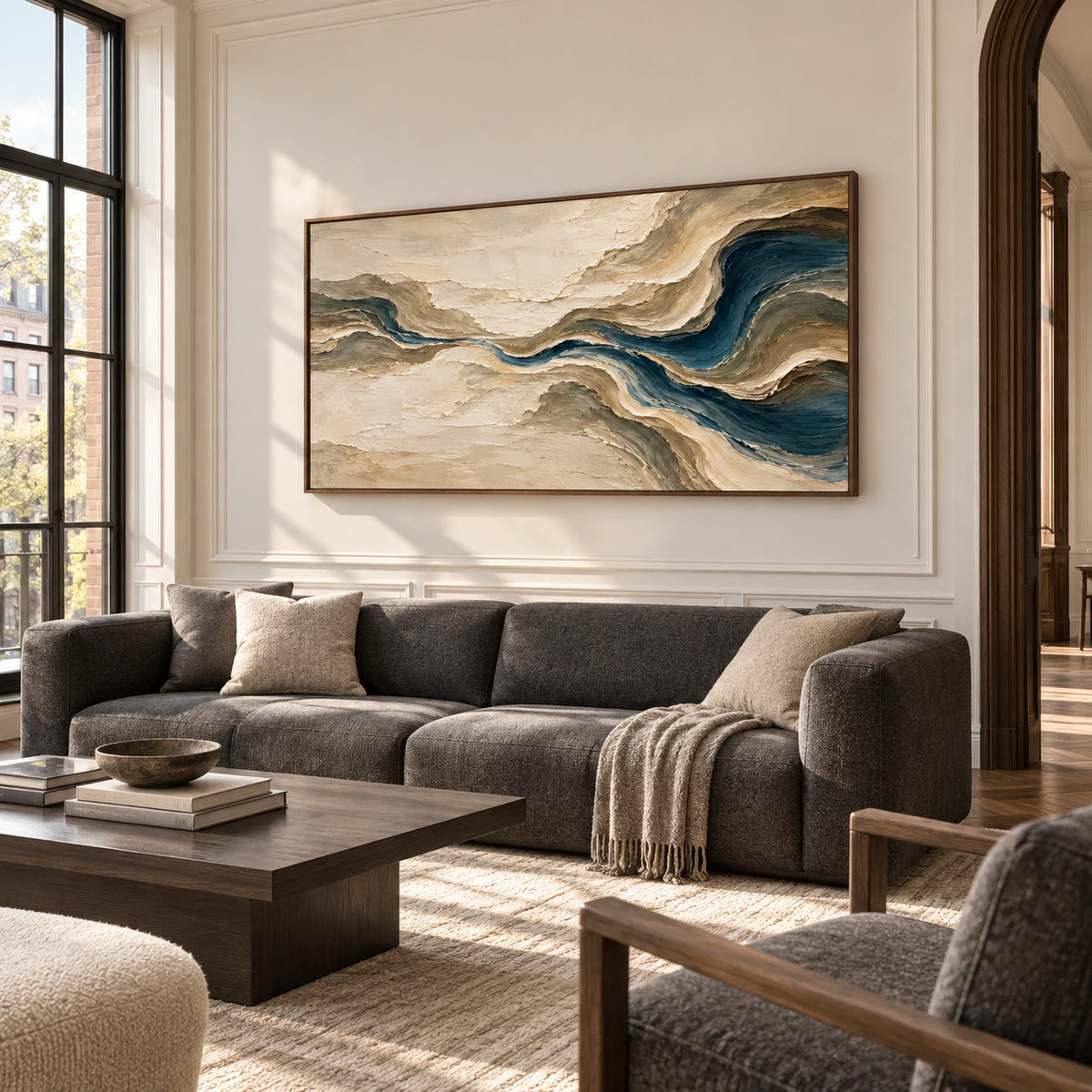 Tidal-Gesso on a pale wall in a traditional living room with dark seating and wood details, viewed obliquely from the right in natural daylight.