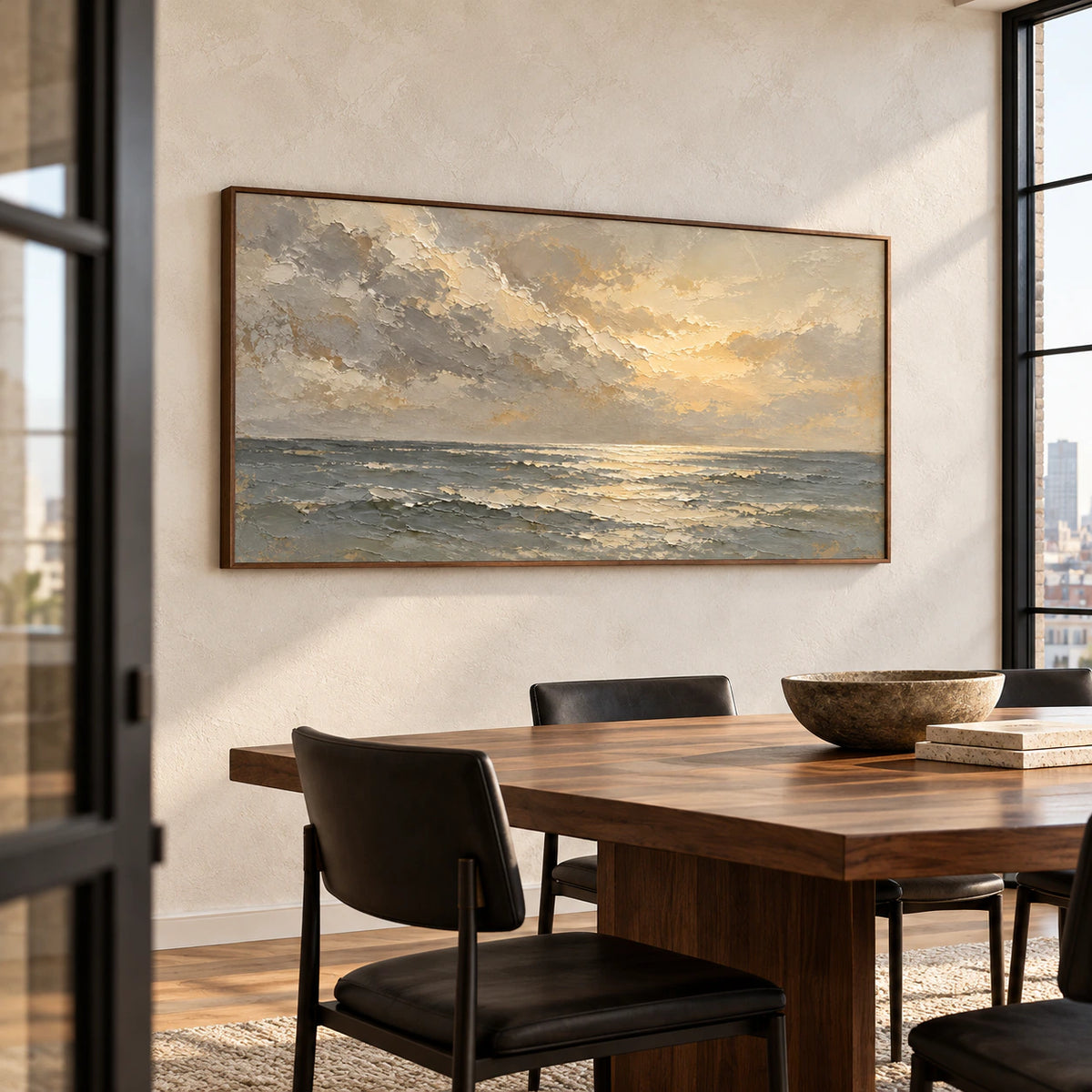 Textured seascape anchoring a refined dining room with a long dark wood table and natural daylight.