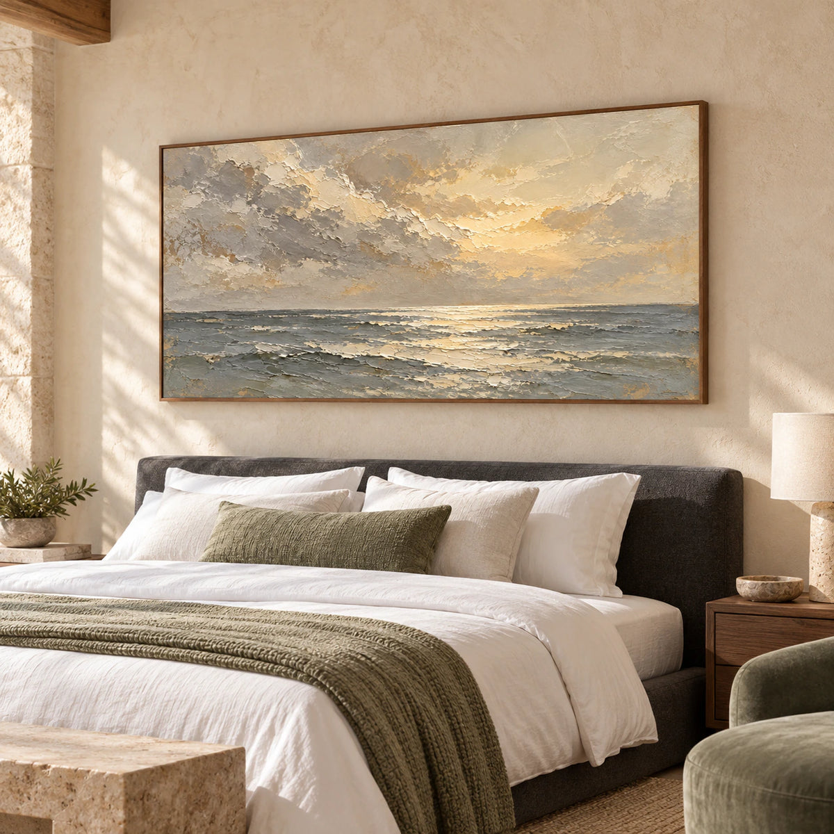 Horizontal seascape above a low bed in a quiet, softly lit bedroom with understated linen bedding.