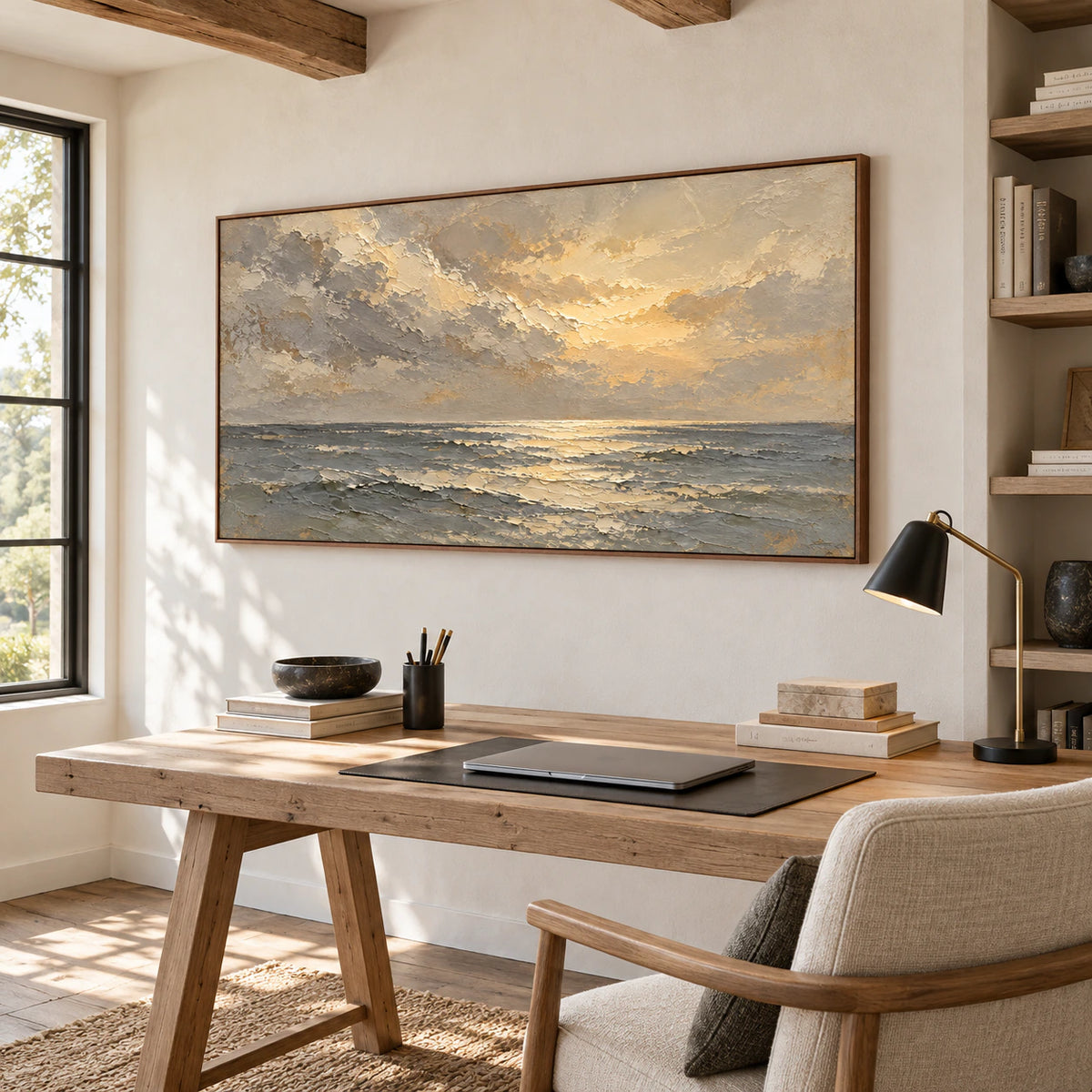 Textured seascape above a desk in an airy home office with open shelving and daylight.