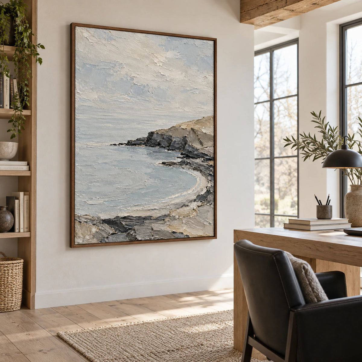Textured coastal artwork in an airy reading and home office space.