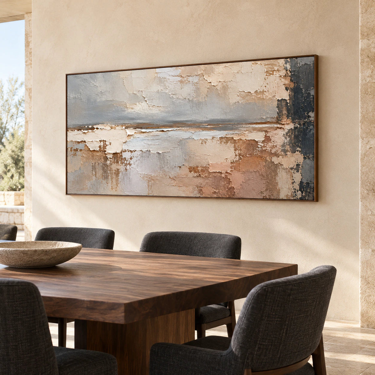 Horizontal abstract painting on a pale plaster wall above a dark wood dining table with contrasting chairs, viewed from the right at seated height.