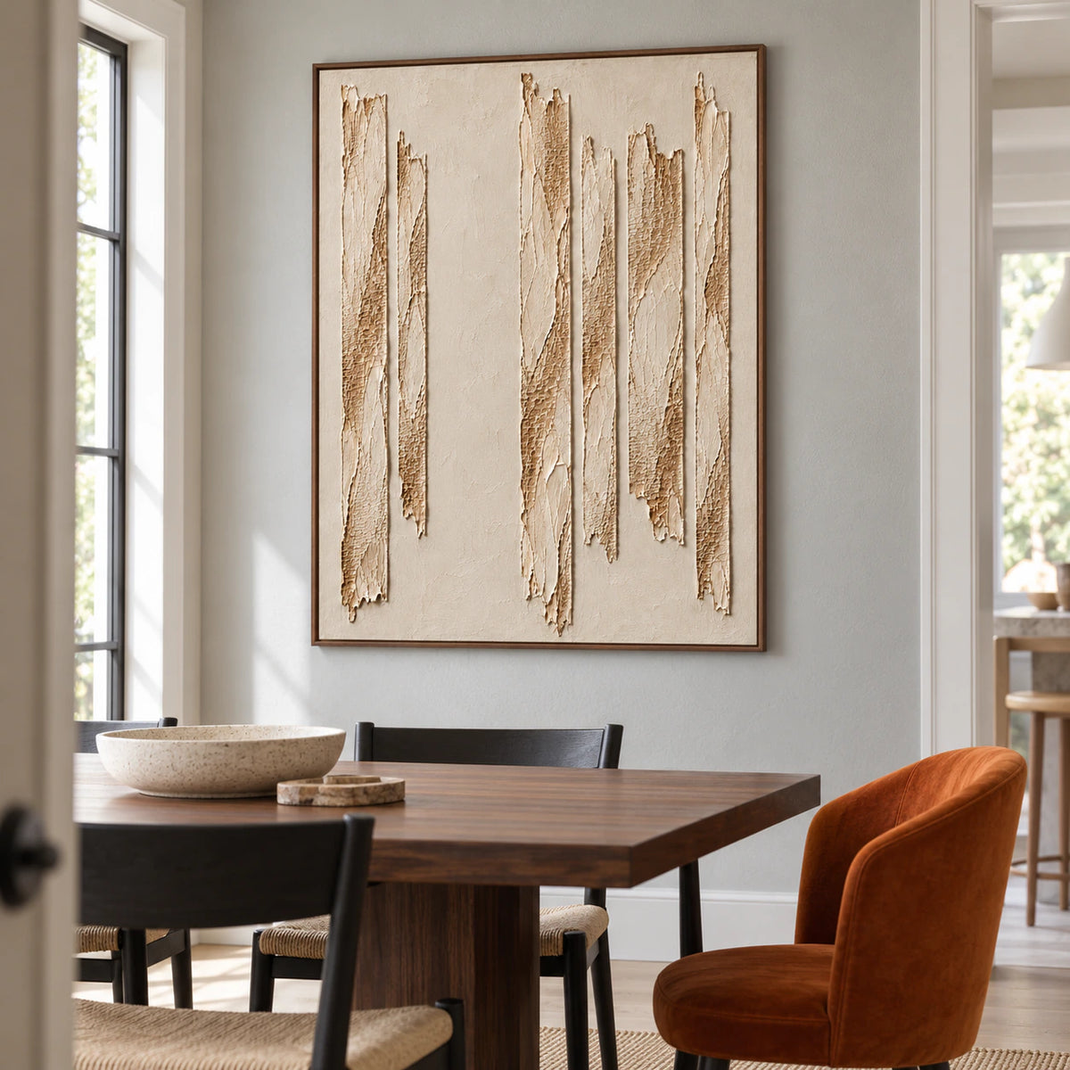 Right-oblique view of Torn-Cadence on a cool gray textured wall beside a dark walnut dining table and black chairs.