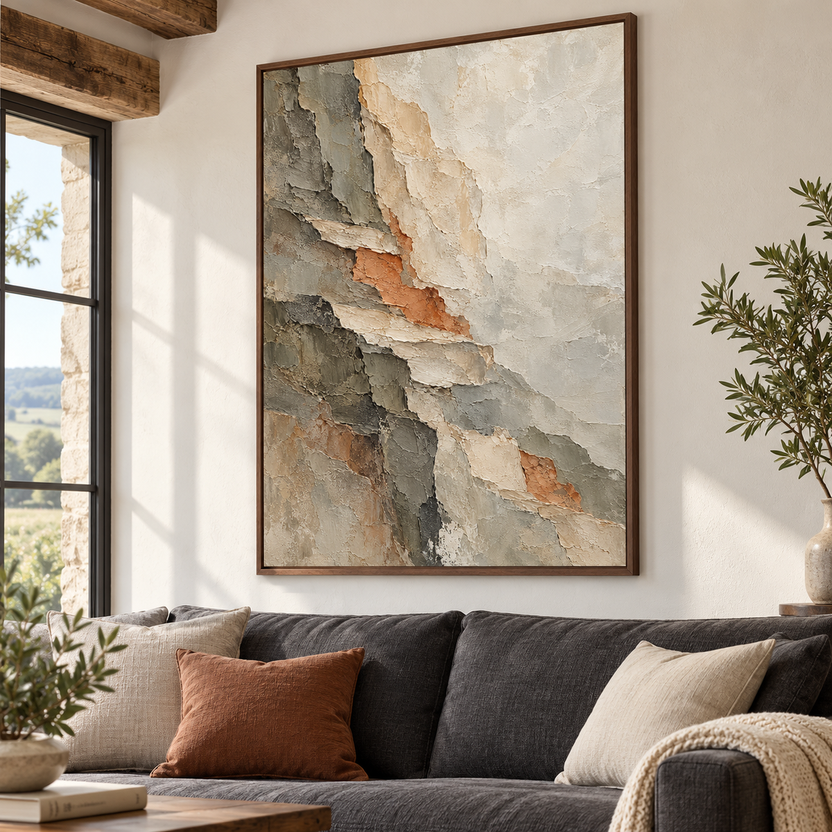 Large vertical abstract painting above a charcoal-gray sofa on a pale living room wall, viewed from a slight left angle at seated eye height in natural daylight.