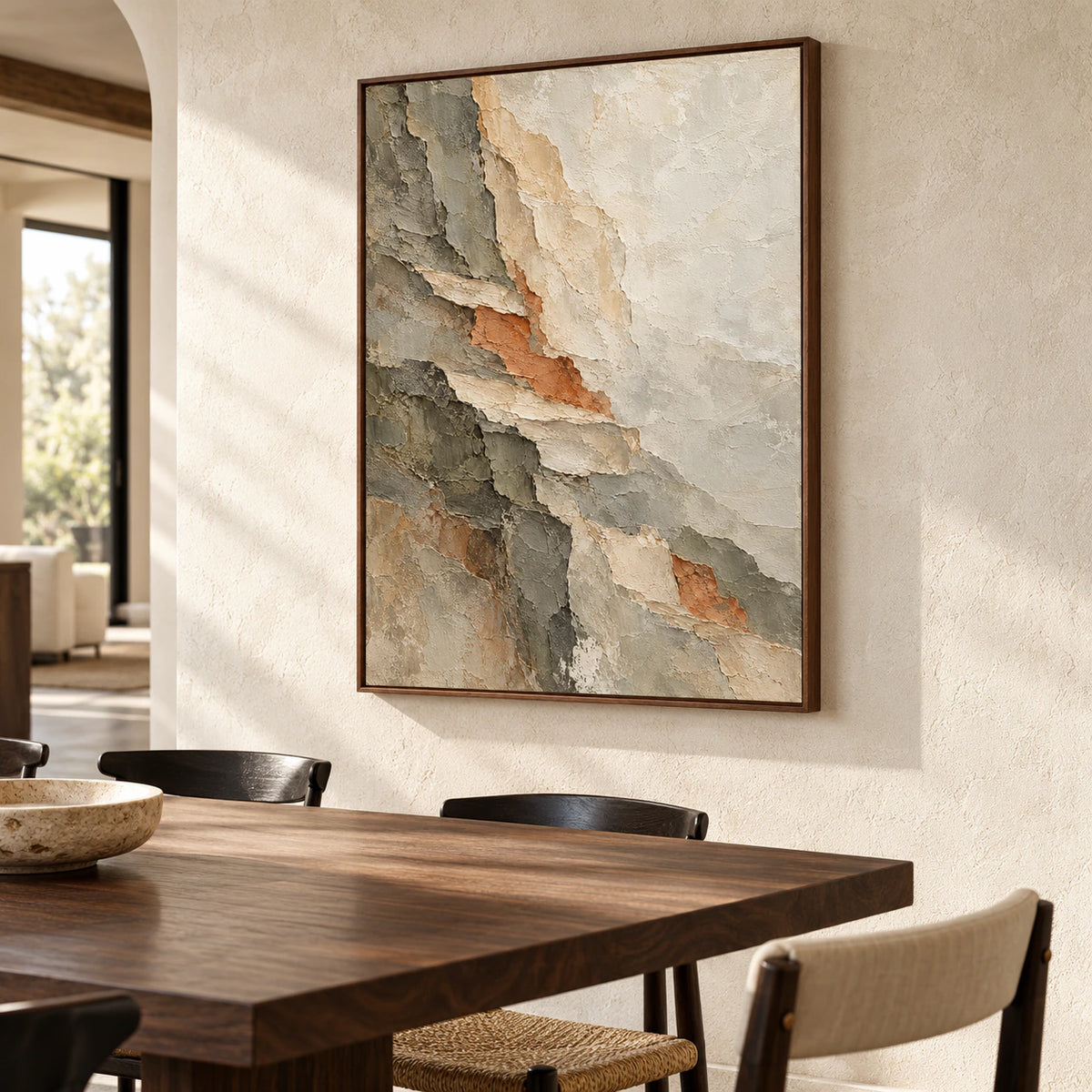Large vertical abstract painting on a light limestone dining room wall with a dark walnut table and simple black chairs, viewed from the right in natural daylight.