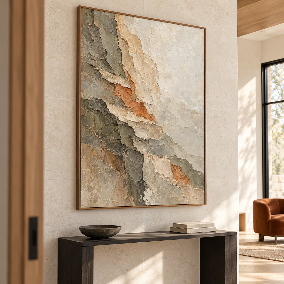 Large vertical abstract painting above a narrow black console on a tall pale stone foyer wall, viewed from the left at a slightly low angle in natural daylight.