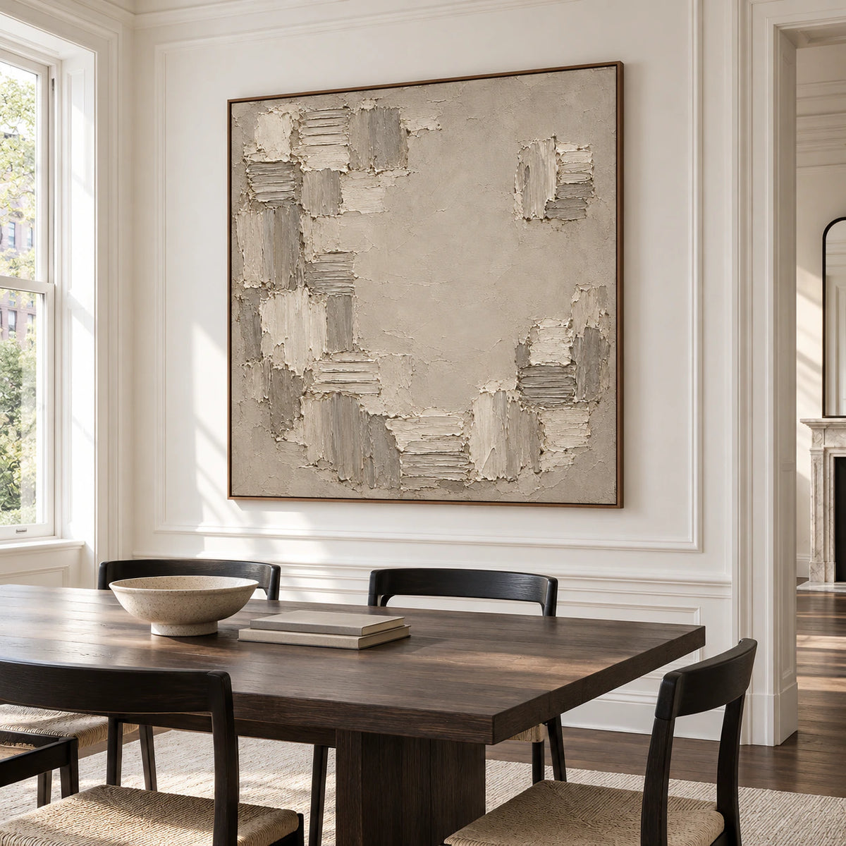 Large Torn-Mosaic artwork anchors a refined dining room, viewed slightly from the left above a dark timber dining table with restrained black chairs and soft daylight.