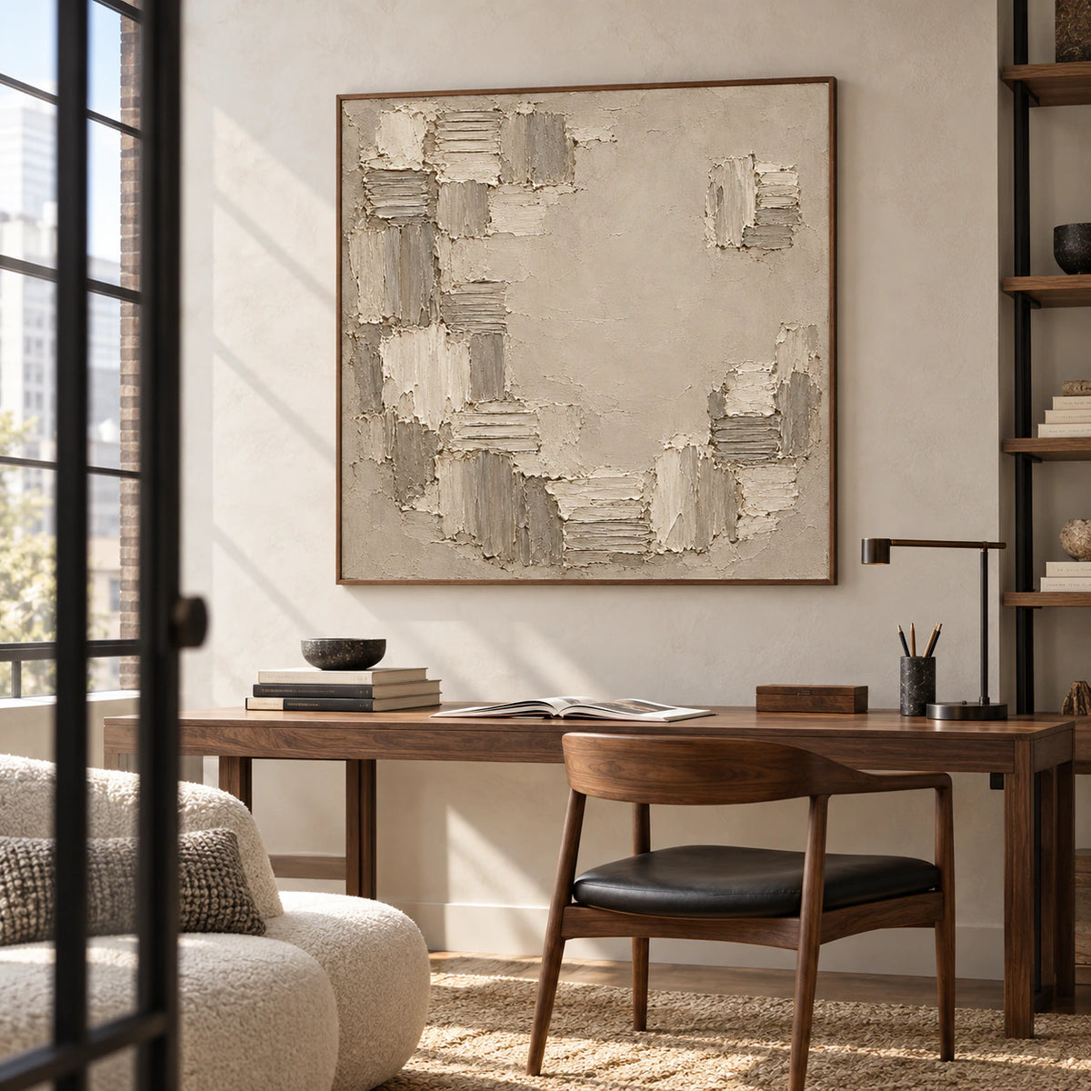 Large Torn-Mosaic artwork is the focus of an airy home office, viewed from a low oblique angle above a simple walnut desk, with open shelves and clear natural daylight.