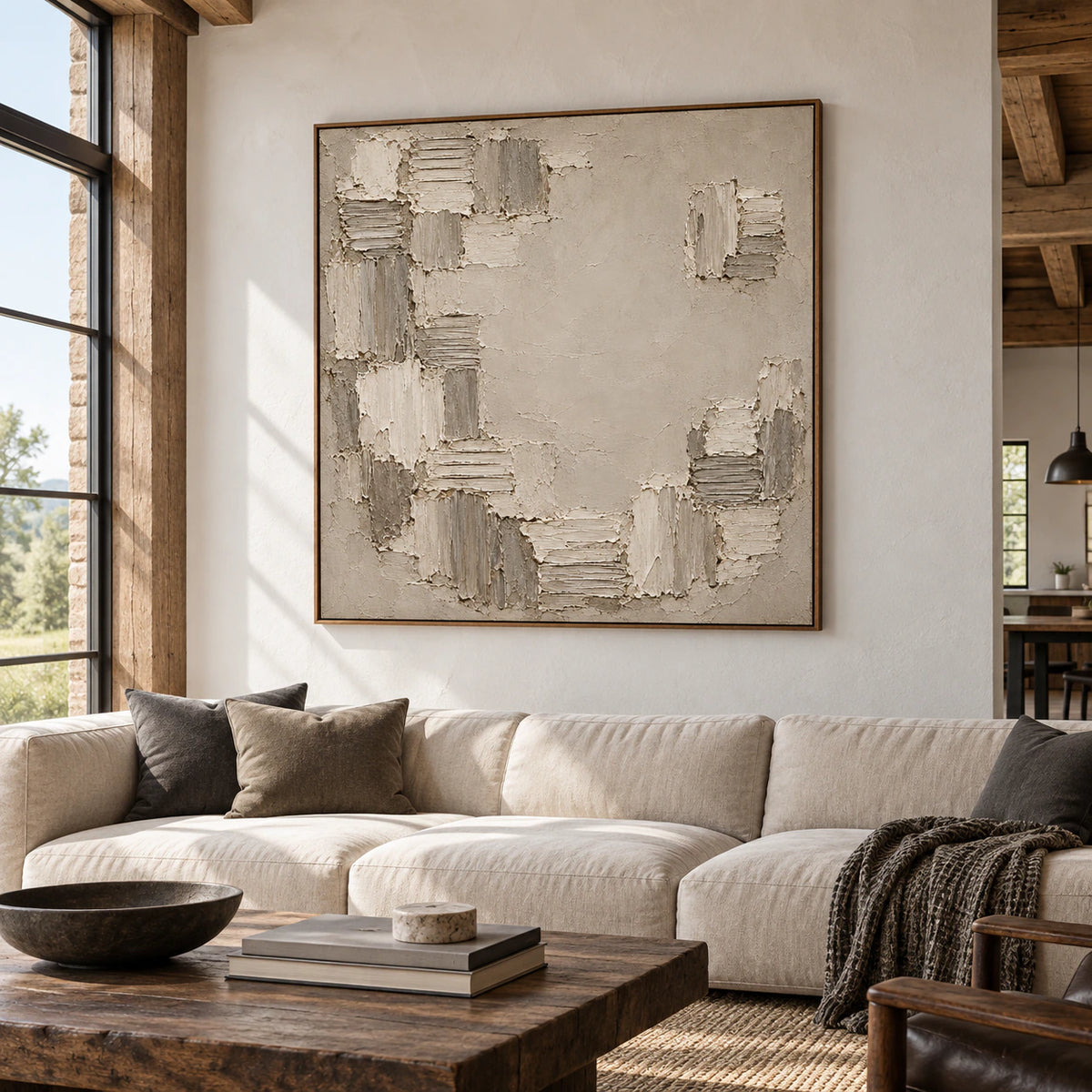Large Torn-Mosaic artwork commands a spacious loft interior with high ceilings and broad windows, viewed from the left across restrained dark furniture and sunlit architectural surfaces.