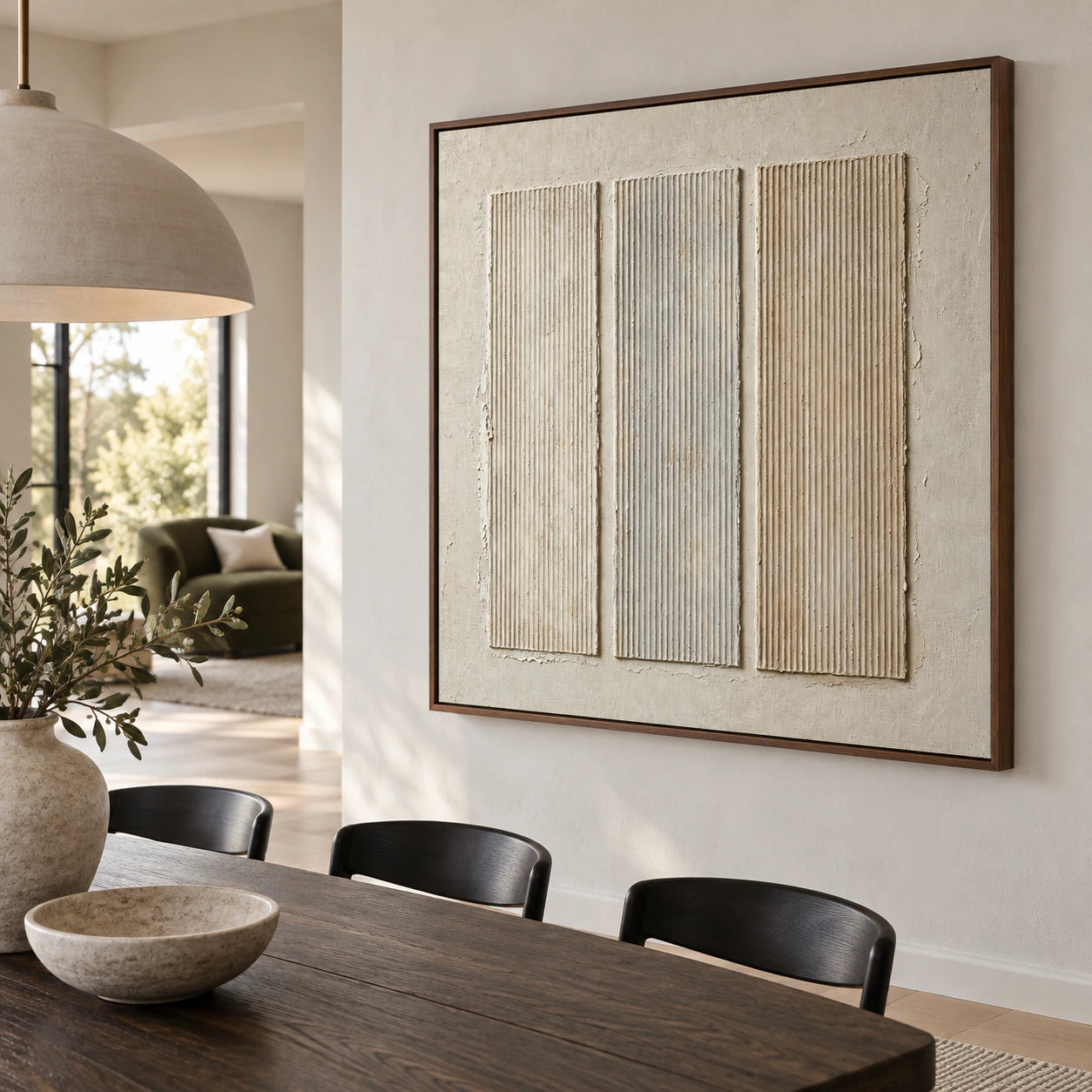 Square ivory relief artwork with three vertical ridged panels in a refined daylight dining room.