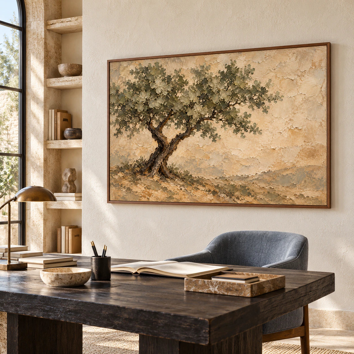 Horizontal tree painting in a bright home office with a dark wood writing desk, blue-gray chair and open shelving, viewed from the right.