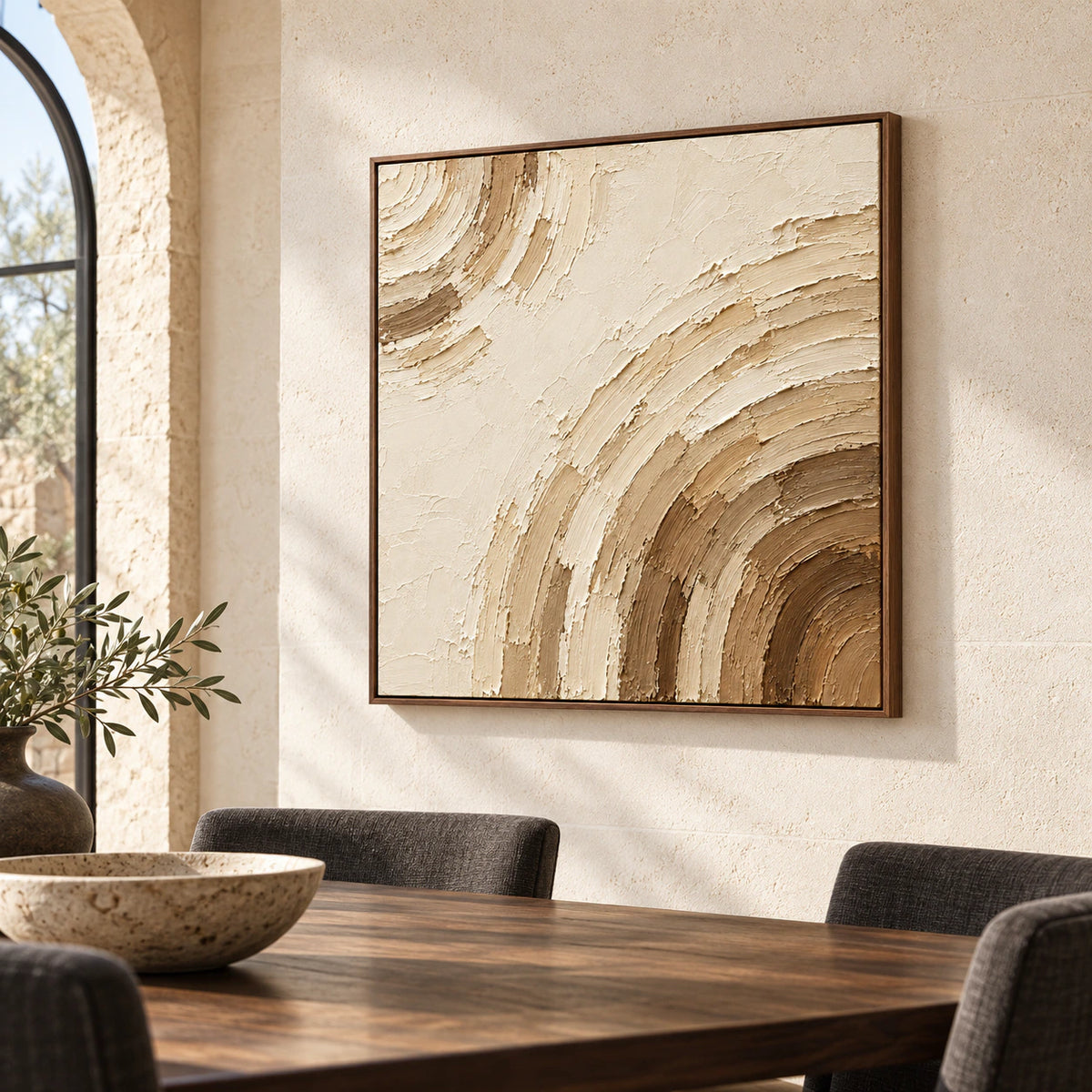 Square ivory and umber abstract painting on a pale limestone wall above a dark walnut dining table with graphite seating, viewed from the right.