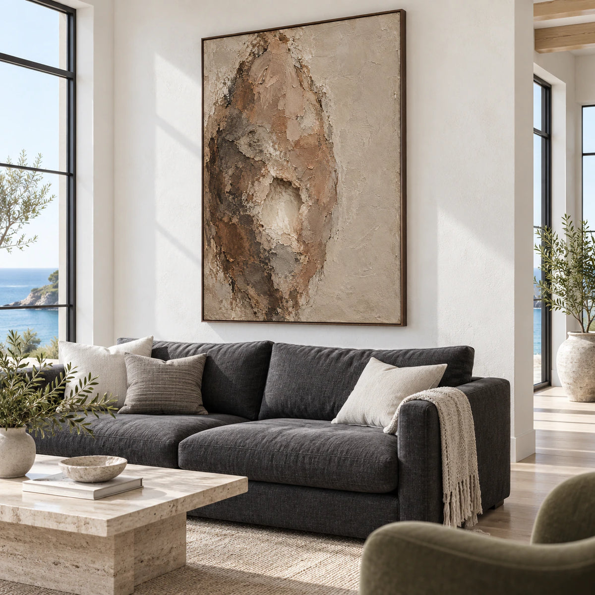 Bright living room with the vertical earth-toned textured abstract painting above a restrained neutral sofa.