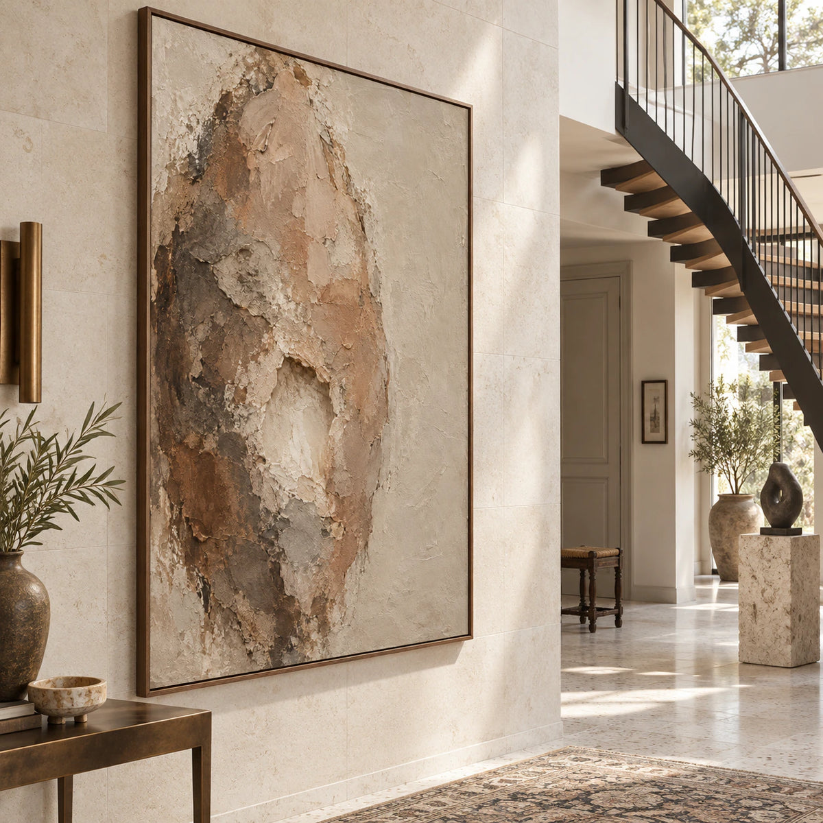 Gallery-scale foyer with the large earth-toned relief painting on a bright architectural wall.