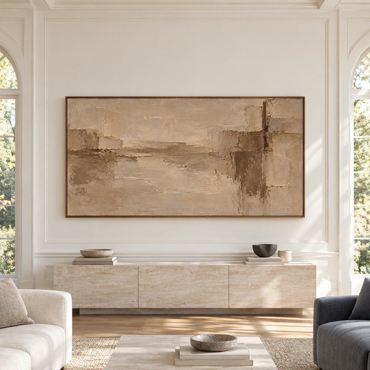 Wide sand, taupe and umber abstract painting viewed straight-on in a spacious, sunlit room with restrained neutral furnishings.