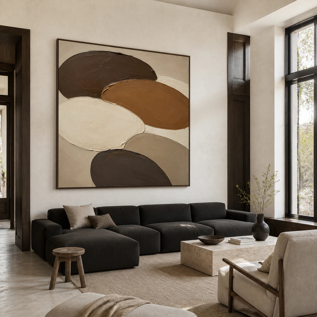 Large Umber-Orbits painting above a restrained sofa in a bright living room.