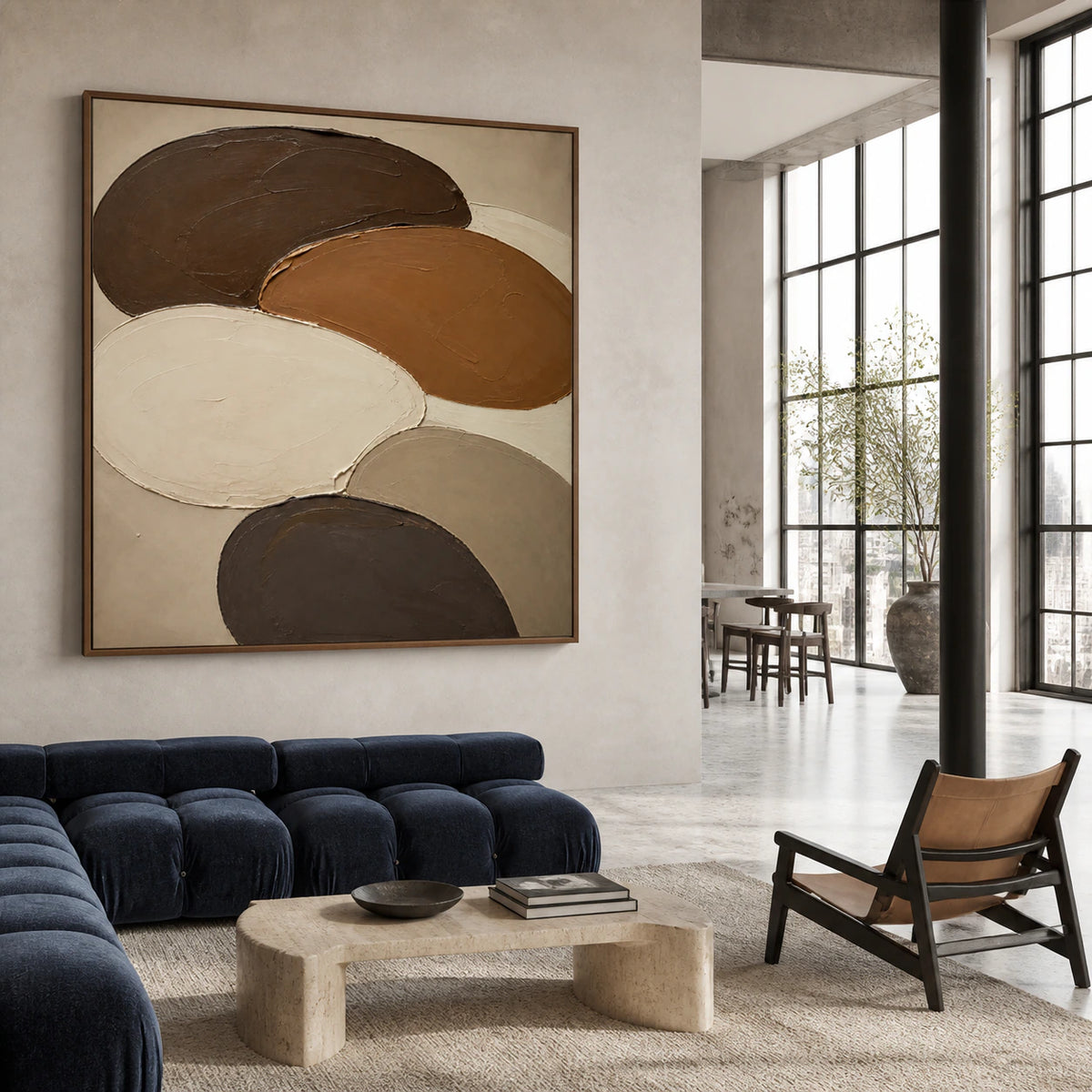 Large Umber-Orbits painting anchoring an expansive loft hospitality interior.