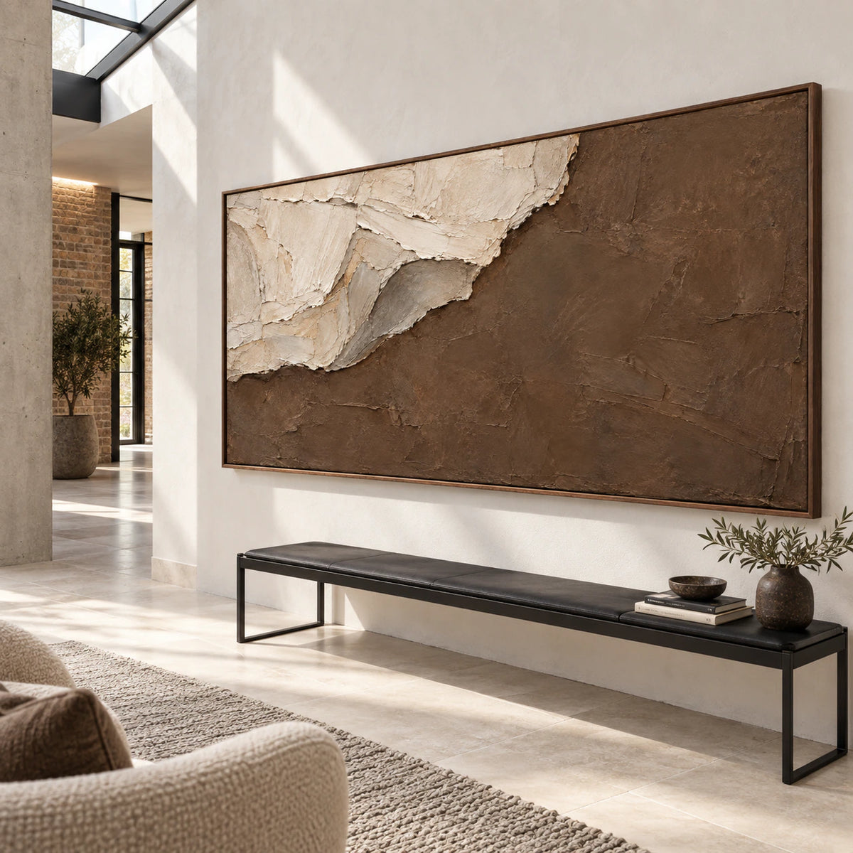 Large ivory and umber textured artwork in a gallery-scale stone foyer.