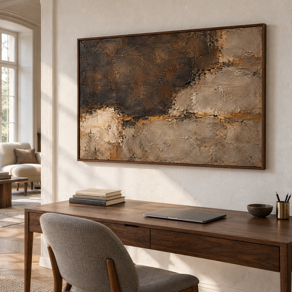 Large horizontal abstract painting above a simple desk in an airy home office with soft natural light.