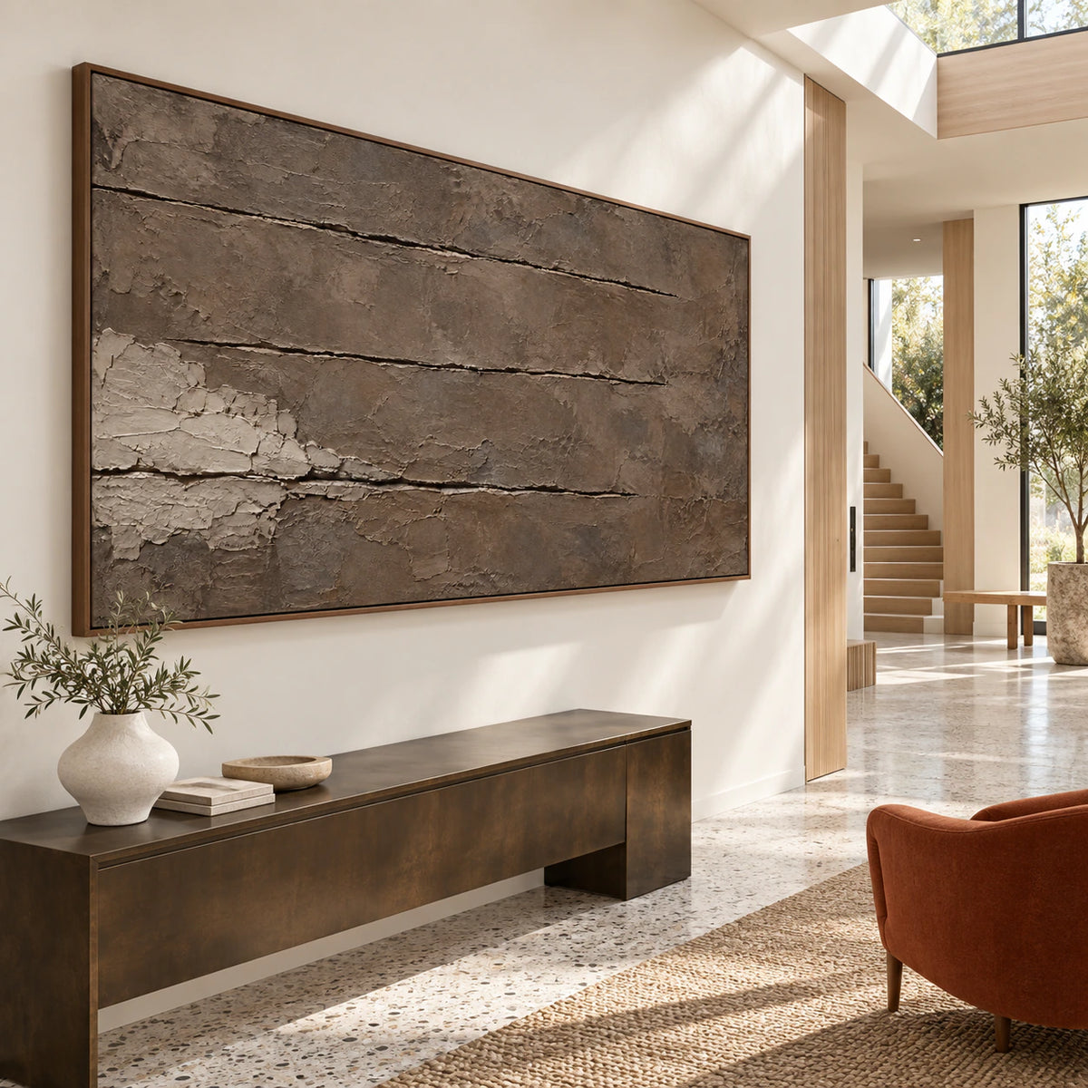 Gallery-scale earth-toned abstract artwork in a bright architectural foyer.