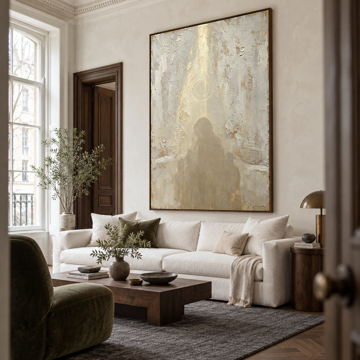 Veiled-Icon as the focal artwork above a restrained sofa in a bright living room.