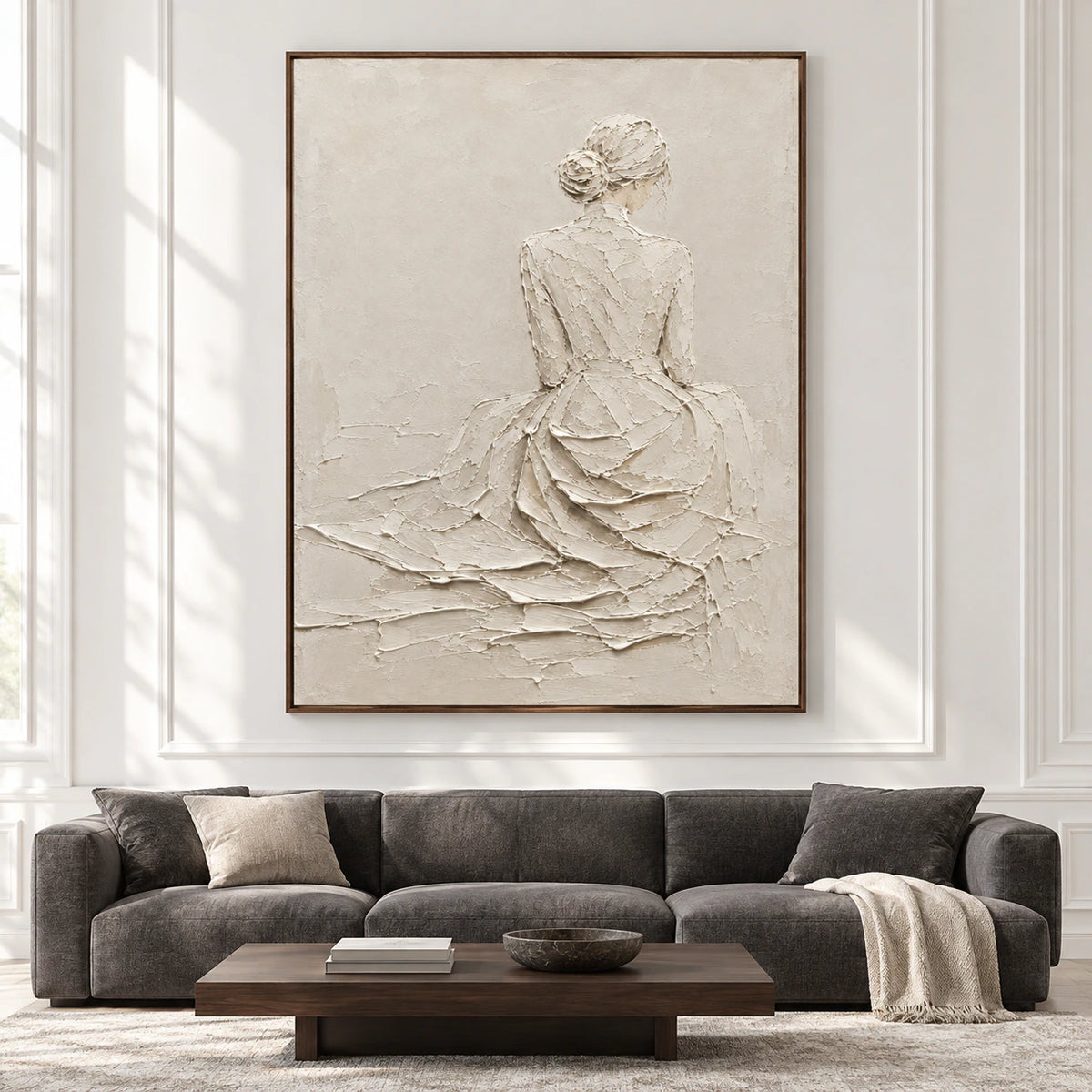 Straight-on view of a large ivory figure painting in a spacious room with restrained contrasting furnishings and bright natural daylight.