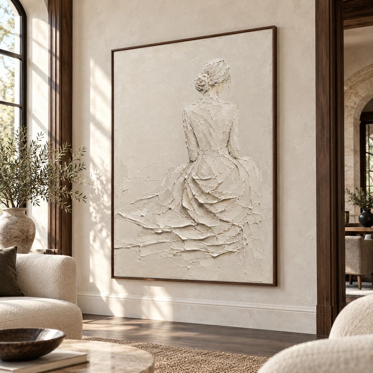 Right oblique view at standing height of a large ivory figure painting on a broad wall in a spacious hospitality loft with dark wood, stone and neutral seating.
