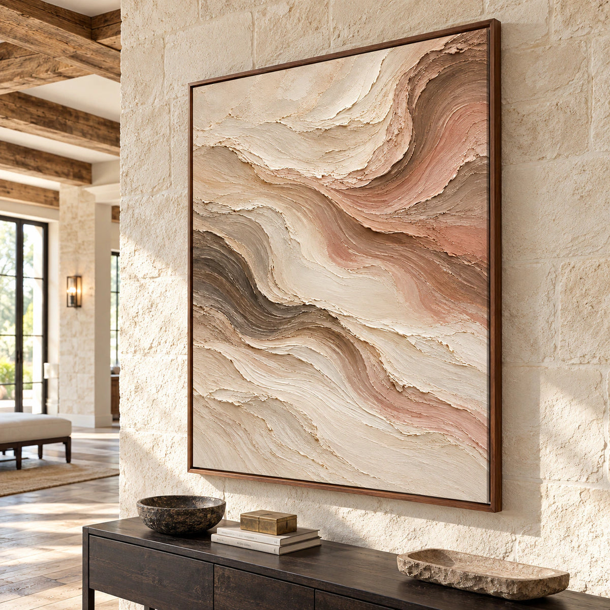 Large vertical abstract painting on a pale stone wall beside a dark console in a tall, bright foyer, viewed from a slightly elevated left approach.