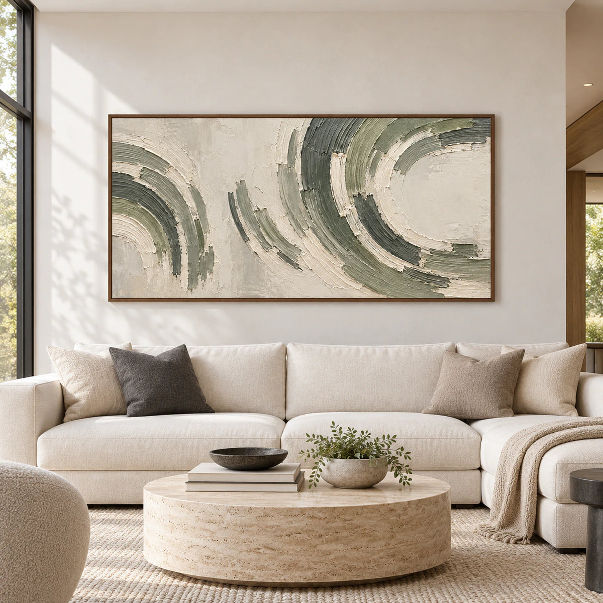 Straight-on view of a large sage and charcoal abstract painting above a sofa in a bright architectural living room with pale stone and light timber furnishings.
