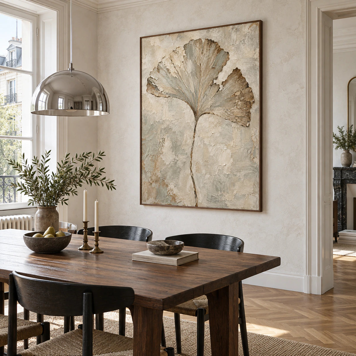 Textured botanical artwork as the focal point of a refined daylight dining room.