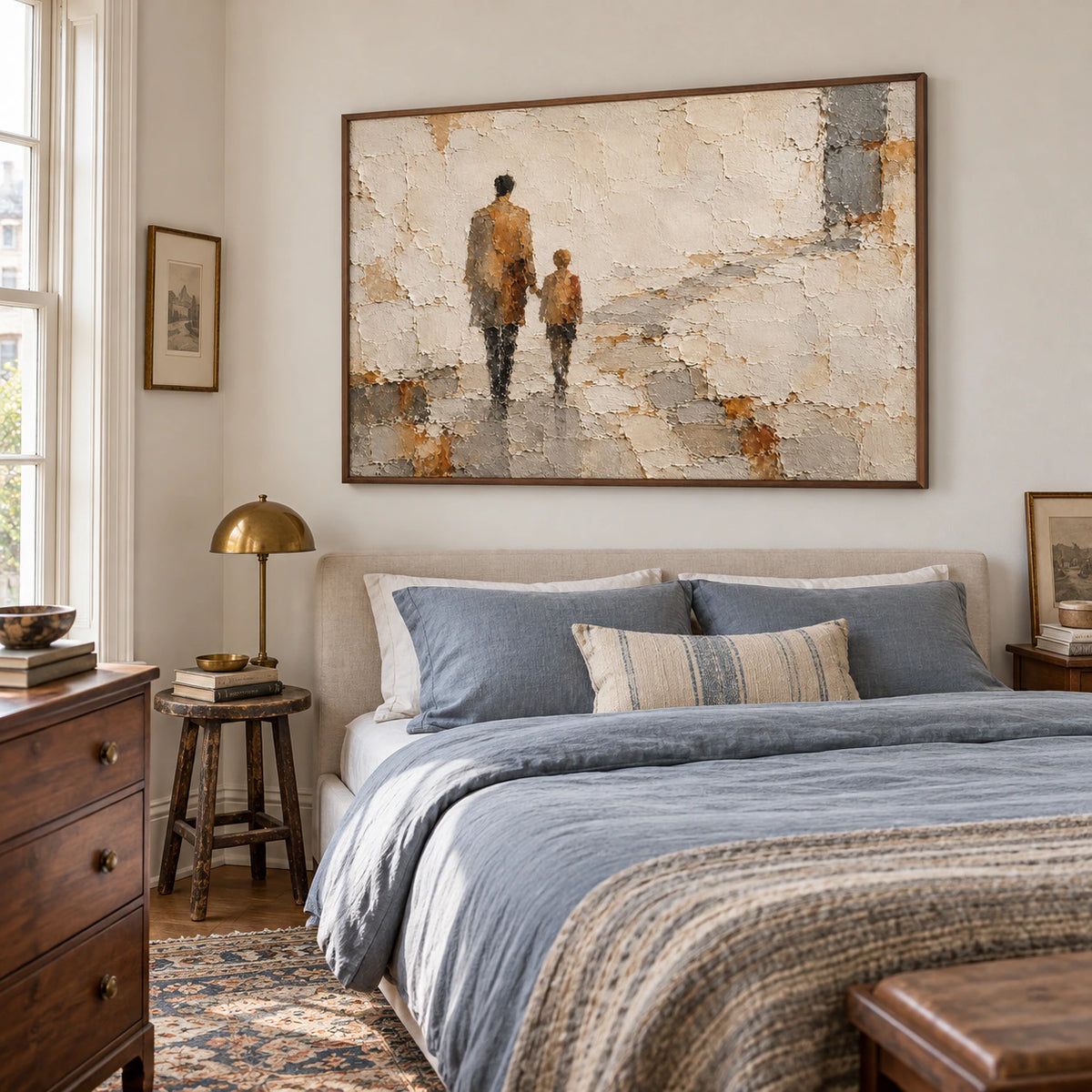 Weathered-Passage painting above a low bed with muted blue-gray linens in a bright bedroom, viewed from a slightly elevated right oblique angle.
